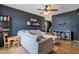 Inviting living room with a large sectional sofa, a ceiling fan, and neutral-toned tiles at 9157 W Gary Rd, Peoria, AZ 85345