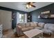Bright living room with dark accent wall, comfortable sofa, and a door that leads to the outside at 9157 W Gary Rd, Peoria, AZ 85345