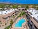A luxurious community boasts landscaped walkways and a sparkling pool surrounded by residential buildings at 9450 E Becker Ln # 1036, Scottsdale, AZ 85260