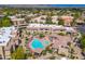 Aerial view features a sparkling pool and spa area surrounded by lush landscaping and residential buildings at 9450 E Becker Ln # 1036, Scottsdale, AZ 85260