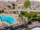A captivating aerial view of a community pool, manicured landscaping, and well-maintained walkways at 9450 E Becker Ln # 1036, Scottsdale, AZ 85260