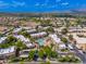 Extensive aerial view of a large community with a central pool and surrounding residential buildings at 9450 E Becker Ln # 1036, Scottsdale, AZ 85260