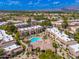 Community aerial view showcases a well-maintained pool area surrounded by lush greenery and residences at 9450 E Becker Ln # 1036, Scottsdale, AZ 85260