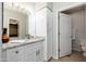 Bathroom featuring a granite countertop vanity, cabinet storage, and access to a closet at 9450 E Becker Ln # 1036, Scottsdale, AZ 85260