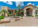 Elegant clubhouse entrance featuring a fountain, palm trees, and lush landscaping at 9450 E Becker Ln # 1036, Scottsdale, AZ 85260