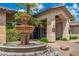 Exterior fountain with water feature, palm trees, and manicured landscaping at the clubhouse entrance at 9450 E Becker Ln # 1036, Scottsdale, AZ 85260
