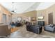 Open-concept common area with a large dining table, cozy seating area, and a wall-mounted television at 9450 E Becker Ln # 1036, Scottsdale, AZ 85260