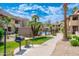 Well-maintained community grounds featuring a barbecue grill and seating area amidst lush landscaping and sidewalks at 9450 E Becker Ln # 1036, Scottsdale, AZ 85260