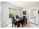 Cozy dining area features a dark wood table and four chairs next to a bright window at 9450 E Becker Ln # 1036, Scottsdale, AZ 85260
