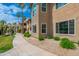 Condominium building with lush landscaping, sidewalk, and mature trees offering a tranquil setting at 9450 E Becker Ln # 1036, Scottsdale, AZ 85260
