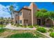Condominium building with lush landscaping, sidewalk, and mature trees offering a tranquil setting at 9450 E Becker Ln # 1036, Scottsdale, AZ 85260