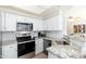 Bright kitchen featuring stainless steel appliances and granite countertops, seamlessly blending style and functionality at 9450 E Becker Ln # 1036, Scottsdale, AZ 85260