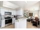 Well-lit kitchen boasts white cabinets, stainless steel appliances, and stylish granite countertops at 9450 E Becker Ln # 1036, Scottsdale, AZ 85260