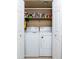 Laundry closet with a stacked washer and dryer and a shelf to store cleaning supplies at 9450 E Becker Ln # 1036, Scottsdale, AZ 85260