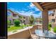 Private patio with outdoor seating, grill, and view of the community pool and landscaped grounds at 9450 E Becker Ln # 1036, Scottsdale, AZ 85260