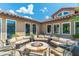Cozy outdoor patio boasts comfortable seating around a stone fire pit, perfect for entertaining at 9450 E Becker Ln # 1036, Scottsdale, AZ 85260