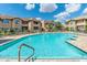 A large inviting community pool is surrounded by lounge chairs and meticulously landscaped buildings at 9450 E Becker Ln # 1036, Scottsdale, AZ 85260