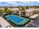 Aerial view of a community tennis court surrounded by lush landscaping and residential buildings at 9450 E Becker Ln # 1036, Scottsdale, AZ 85260
