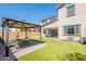 Backyard featuring lush turf, patio, and a charming gazebo with outdoor seating at 98 N Bay Dr, Gilbert, AZ 85233