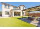 Backyard with artificial grass, patio, and inviting seating area with shade structure at 98 N Bay Dr, Gilbert, AZ 85233
