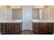 Bathroom featuring double sinks with dark wood cabinets and large mirrors at 98 N Bay Dr, Gilbert, AZ 85233