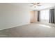 Bedroom featuring neutral walls, carpet flooring, and a bright window with dark curtains at 98 N Bay Dr, Gilbert, AZ 85233