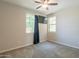 Cozy bedroom with neutral carpet, ceiling fan, and ample natural light at 98 N Bay Dr, Gilbert, AZ 85233