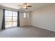 Spacious bedroom with large window offering outdoor views and a modern ceiling fan at 98 N Bay Dr, Gilbert, AZ 85233