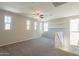 Spacious bonus room with ample natural light, carpet flooring and a ceiling fan at 98 N Bay Dr, Gilbert, AZ 85233