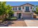 Charming two-story home boasts a landscaped yard, attached two-car garage, and an inviting front door at 98 N Bay Dr, Gilbert, AZ 85233