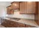 Close-up of the granite countertop and cabinetry of the kitchen with stainless appliances at 98 N Bay Dr, Gilbert, AZ 85233