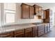 Close-up of a kitchen with granite counters, wood cabinets, and stainless appliances at 98 N Bay Dr, Gilbert, AZ 85233