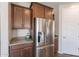 View of the stainless steel refrigerator and granite counters within the kitchen at 98 N Bay Dr, Gilbert, AZ 85233
