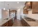 Spacious kitchen featuring a central island, stainless steel appliances, and wood flooring at 98 N Bay Dr, Gilbert, AZ 85233