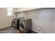 Convenient laundry room with modern washer and dryer, shelving and wood-look floors at 98 N Bay Dr, Gilbert, AZ 85233