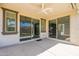 Covered outdoor living space features a ceiling fan and sliding glass doors to the home's interior at 98 N Bay Dr, Gilbert, AZ 85233