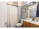 Stylish bathroom with a patterned shower curtain, blue walls, and a wood vanity at 9816 E Stone Circle E Ln, Gold Canyon, AZ 85118