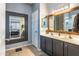 Modern bathroom with a double sink vanity, neutral tile floors, and a framed mirror at 9816 E Stone Circle E Ln, Gold Canyon, AZ 85118
