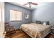 Comfortable bedroom with a ceiling fan, natural light, and wood-look floors at 9816 E Stone Circle E Ln, Gold Canyon, AZ 85118