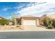 Charming single-story home with a two-car garage and desert landscaping on a sunny day at 9816 E Stone Circle E Ln, Gold Canyon, AZ 85118