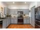 Modern kitchen with gray cabinets, granite countertops, and stainless steel appliances at 9816 E Stone Circle E Ln, Gold Canyon, AZ 85118