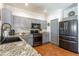 Elegant kitchen featuring granite countertops, gray cabinetry, and tiled flooring at 9816 E Stone Circle E Ln, Gold Canyon, AZ 85118