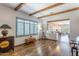 Well-lit living room showcasing exposed beam ceilings and stylish window shutters at 9816 E Stone Circle E Ln, Gold Canyon, AZ 85118