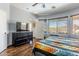 Cozy main bedroom with an open door, a modern dresser, and a large window at 9816 E Stone Circle E Ln, Gold Canyon, AZ 85118