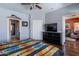 Bright main bedroom with a comfortable bed, closet access, and wood-look floors at 9816 E Stone Circle E Ln, Gold Canyon, AZ 85118
