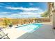 Inviting outdoor pool with desert views, surrounded by a concrete patio and mature landscaping, perfect for relaxation at 9816 E Stone Circle E Ln, Gold Canyon, AZ 85118