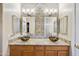 Bathroom featuring granite countertop, vessel sinks, designer tile backsplash, and upgraded lighting fixtures at 992 S Roanoke St, Gilbert, AZ 85296