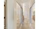 Hallway of a bathroom with a large mirror, ample lighting, a linen closet, and dual sinks at 992 S Roanoke St, Gilbert, AZ 85296