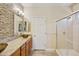 Modern bathroom featuring dual sinks, granite countertops, and a glass-enclosed shower at 992 S Roanoke St, Gilbert, AZ 85296