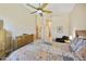 Spacious bedroom with a decorative quilt, wood-look tile and dresser that maximizes functionality and storage at 992 S Roanoke St, Gilbert, AZ 85296
